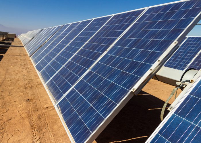RGTMRY Hundreds solar energy modules or panels rows along the dry lands at Atacama Desert, Chile. Huge Photovoltaic PV Plant in the middle of the desert